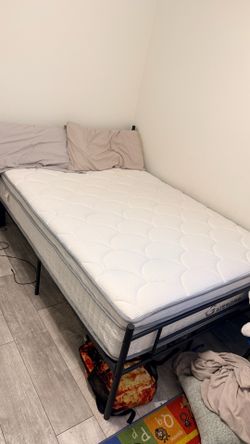 Full size bed frame and mattress.
