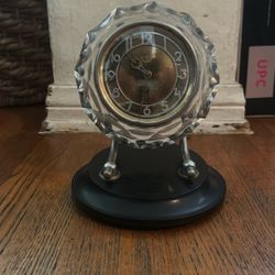 This is a vintage Soviet Majak mechanical table clock with an Art Deco cut crystal case and a black base.  Made in the USSR, likely from the 1960s or 