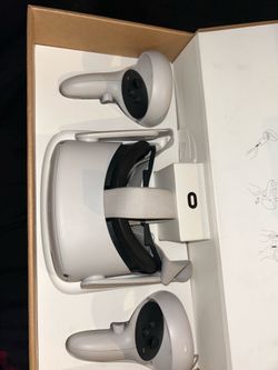 Meta Quest 2 VR headset with 2 controllers, box included.