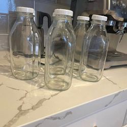8 thick glass bottles with lids , 32 ounce each