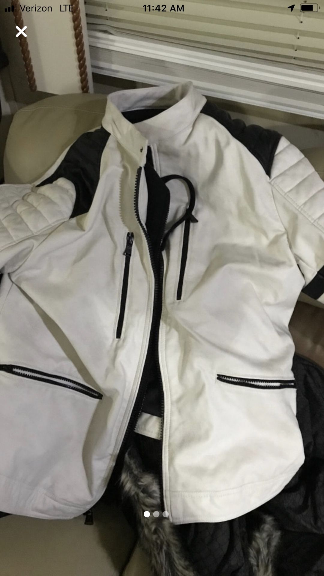 Leather jacket size XL white with black with hoodie inside that zips off.