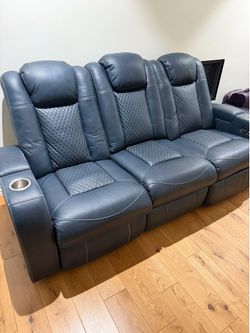 Almost new leather sofa with electric recliner both sides.
