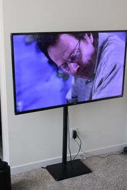 55" 4K UHD TV (Model: ONA55UB19E06) with TV stand.