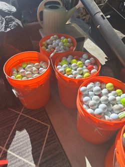Multiple Buckets Of Golf Balls