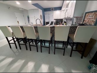 Six beige bar stools