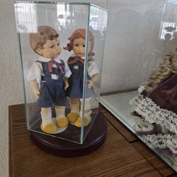 Dolls In Glass Case
