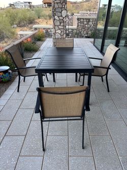 Patio table with leaf extension and four chairs
