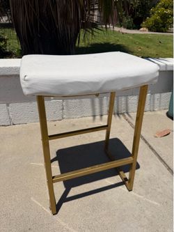 White chair with golden legs