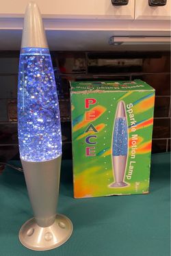 Amazing piece of nostalgia NEW in box. Blue/purple glitter motion lamp