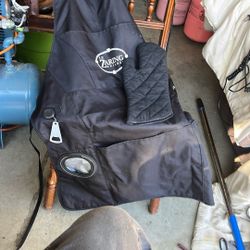 The image shows a black grilling apron with a matching oven mitt. The apron has a logo that appears to say "LT ZARING BUILDER." 