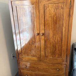 Solid wood entertainment center.   Tv not included.