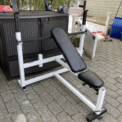 Heavy duty adjustable bench with attached preacher curl and leg attachments