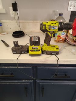 Ryobi drill with three batteries and charger