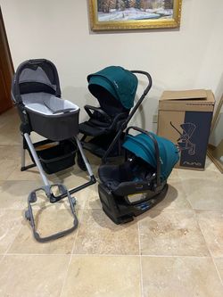 Nuna Mixx Next stroller with car seat and bassinet with stand green canopy