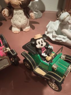 Walt Disney, Mickey Mouse, wind up cars.\nWorkGreat, it's Walt Disney production on the bottom.I've had these since nineteen seventy two