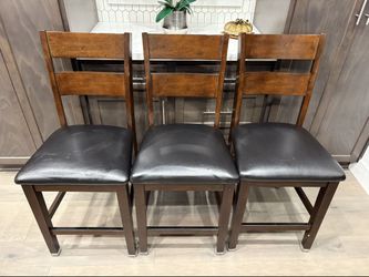 3-piece set of 24-inch solid wood barstools with leather seats, in good condition and very comfortable.