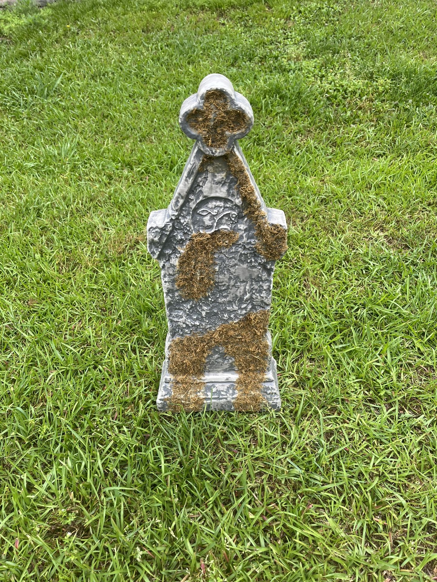 Tombstone With Fake Vines Growing Up It