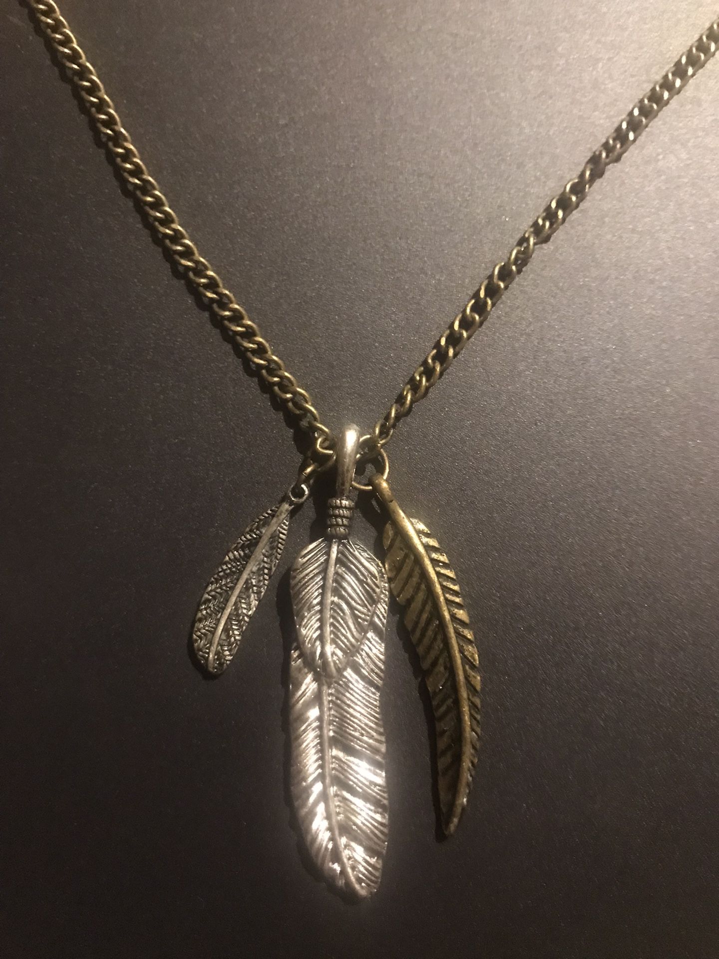 Silver and gold color long necklace with metal feathers