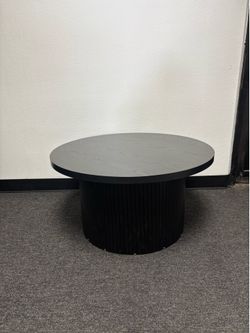 Black coffee table with fluted base