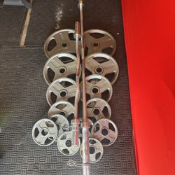 Olympic weights 255lbs total plus 7ft 45lbs bar and curl bar