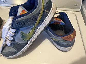 Nike SB Dunk Low Pro "Why So Sad?" sneaker in Coastal Blue and Light Current Blue with a yellow wear-away Swoosh