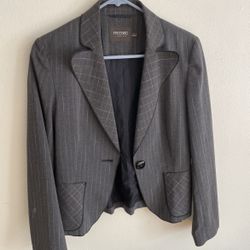 This is a grey striped women's suit set. • The fabric is a blend or wool-like formal fabric in a medium grey color. • Pattern: The main body features 