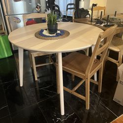 Round light wood dining table 