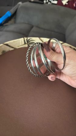 Four silver bangles and one silver twisted bangle