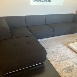 4pc sectional  grayish black with accent chrome rail at bottom for sleek look