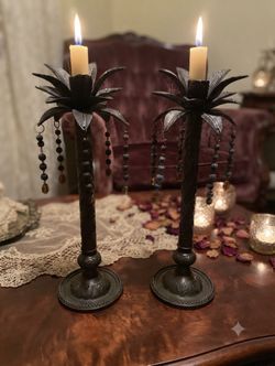 A set of palm tree metal candle holders