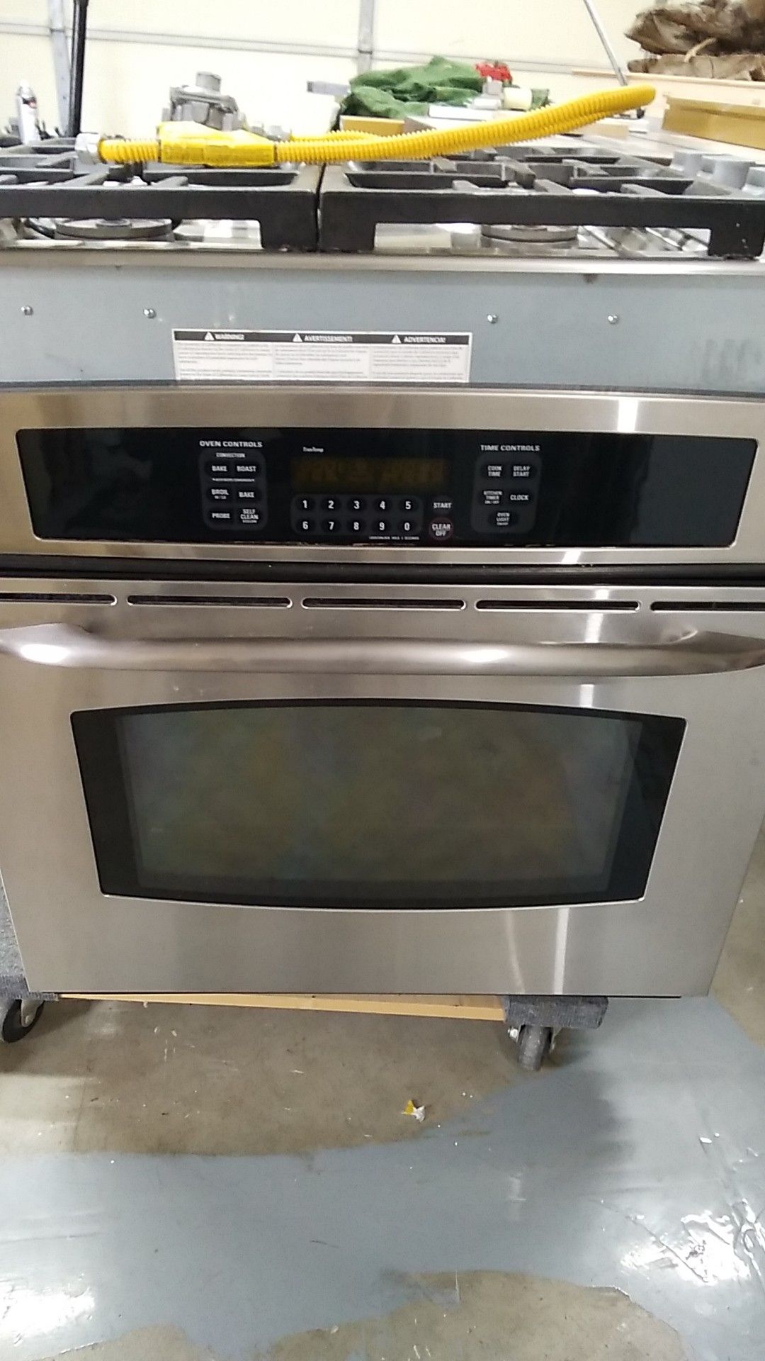 GE profile electric oven & separate DCS by Fisher & Paykel gas cooktop