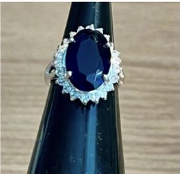 This stunning silver ring features a captivating blue gemstone, perfect for adding a touch of elegance to any outfit. Sliver ring . As is. No returns.