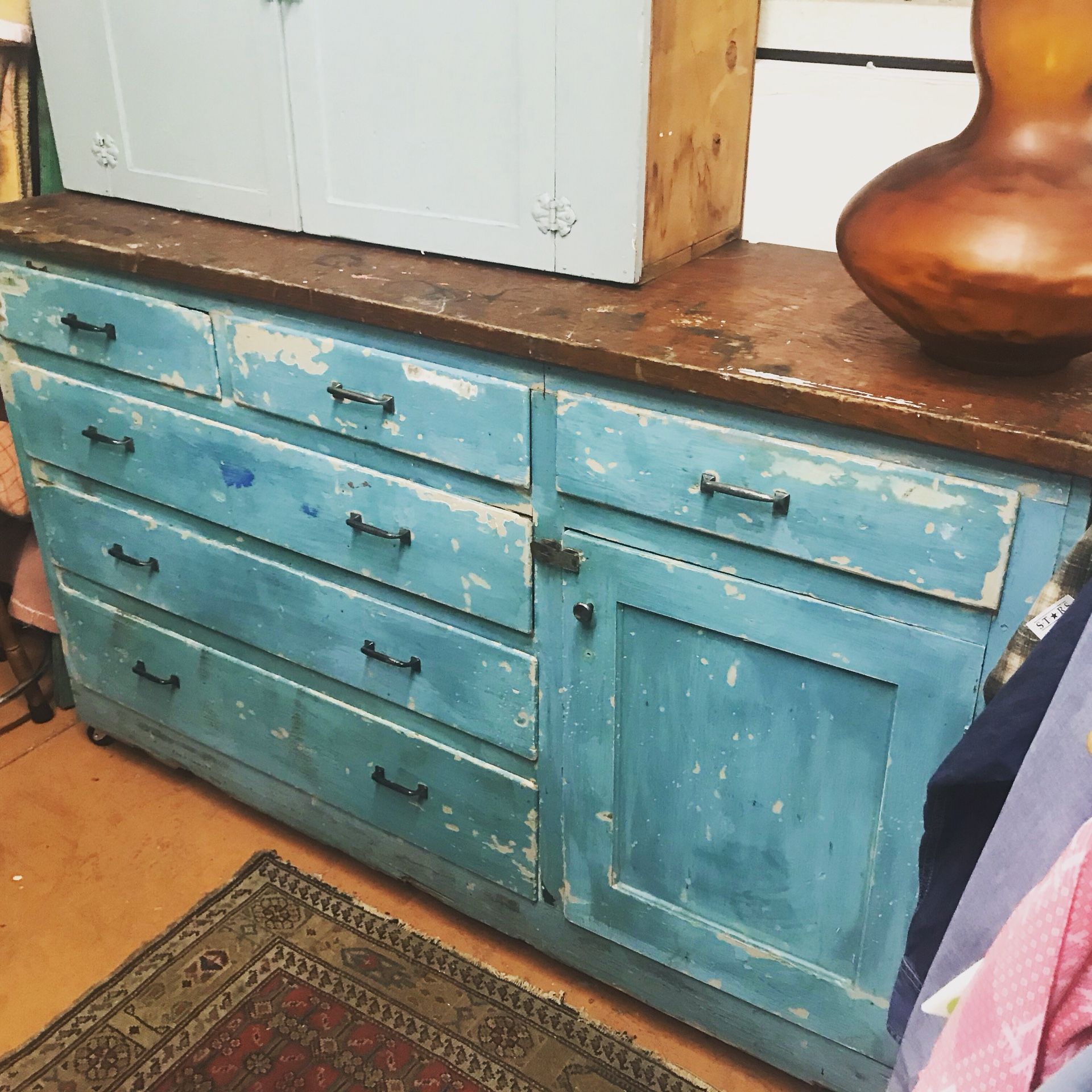 Antique farm cabinet/workbench. It’s on wheels and easy to move. Solid natural wood top. 5’ long x roughly 40” tall. It was a built-in, converted to