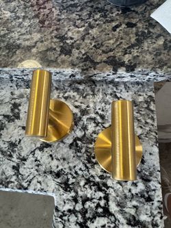 Gold stainless steel robe and towel hook set features a modern cylindrical design
