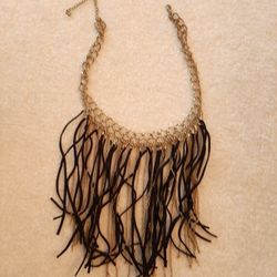 Black Leather fringe necklace with gold tone strands.