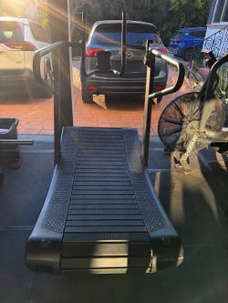 Commercial-grade curved manual treadmill