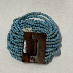 bracelet with wood clasp and multiple strands of turquoise beads pre owned 