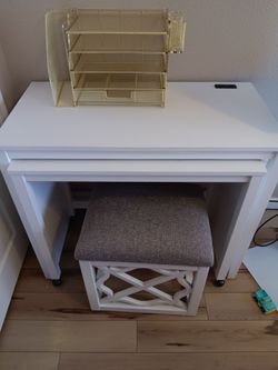 White desk with stool and gold file organizer
