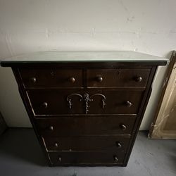 Vintage mahogany dresser with glass top.