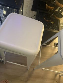 Three metal barstools with swivel tops