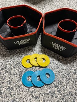The Folding Washer Toss Washers Game Set includes 2 targets and yellow/blue washers, providing all the necessary components for a fun outdoor game. Th