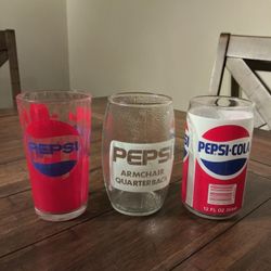 Collectible Pepsi glasses.  One a football, One a Pepsi can, and one a Prism.