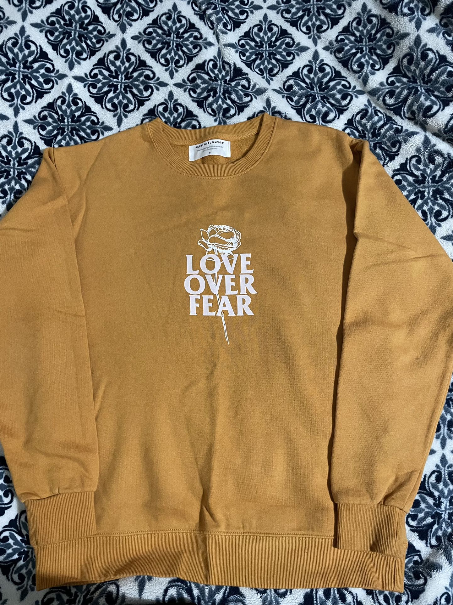 Seek Discomfort Orange Love Over Fear Sweatshirt  XS