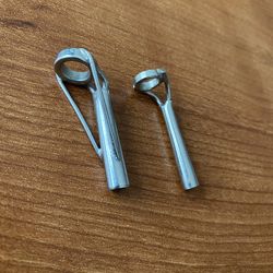 Set of two metal fishing rod guides.