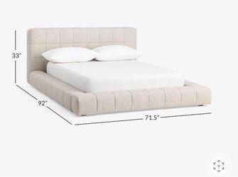 a Pottery Barn Baldwin upholstered queen frame.