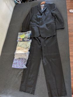 Black Calvin Klein suit, 4 dress shirts, 7 ties