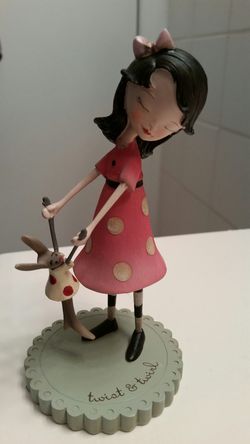 Girl with bunny figurine