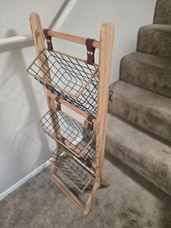 Wooden ladder rack with hanging wire storage baskets