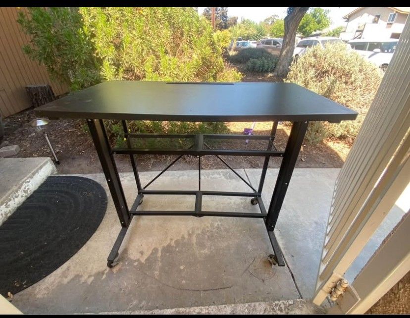 Adjustable height collapsible desk.