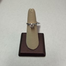 14kw .89ct Solitaire Set On A Fleur Head. 